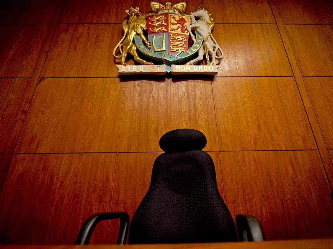 A chair inside a courtroom.