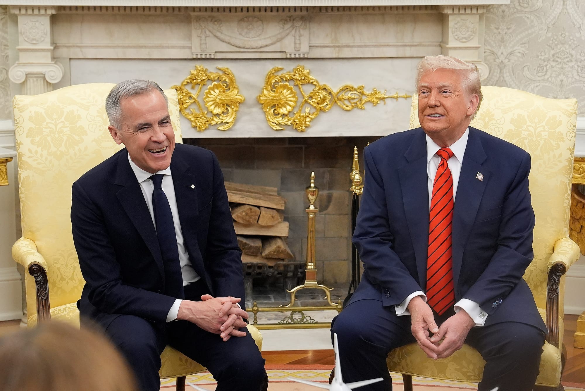 Mark Carney and Donald Trump smile at a meeting in the White House