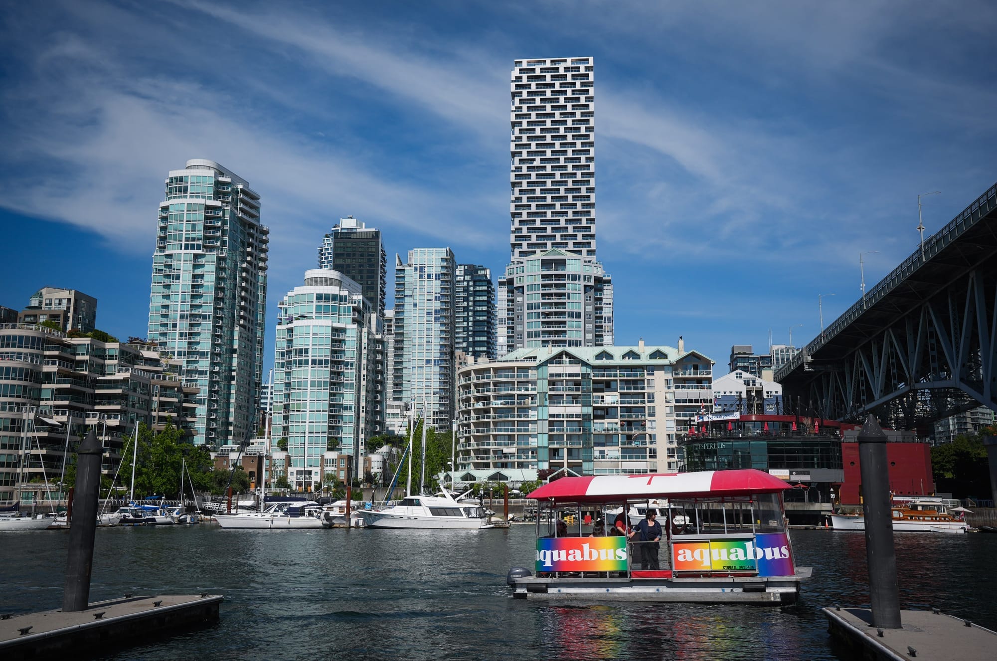 An Aquabus water taxi carrying tourists prepares to dock at Granville Island in Vancouver.