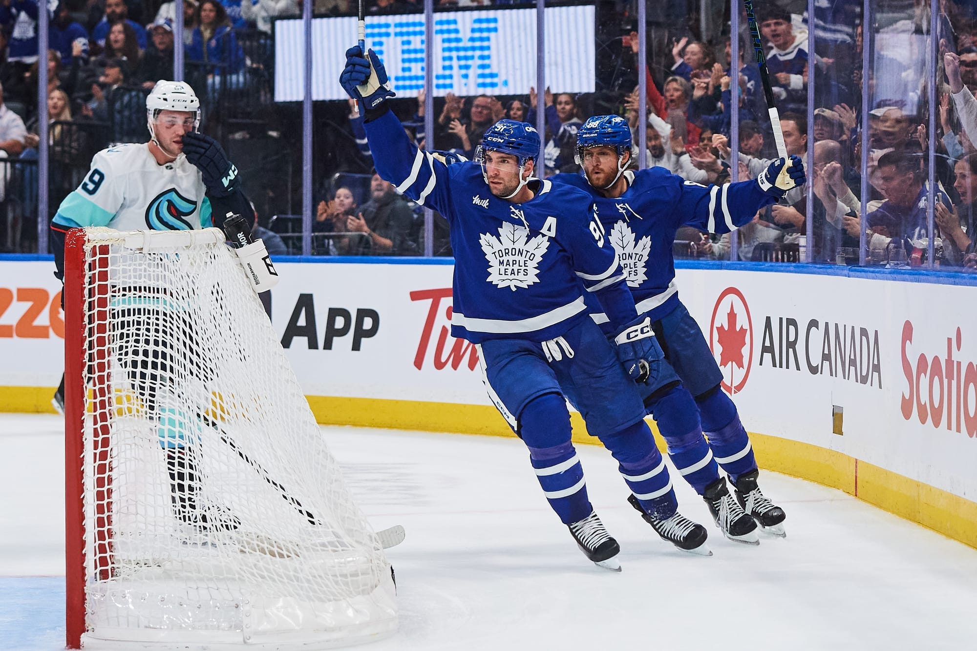 Toronto Maple Leafs' John Tavares (91) celebrates his goal against the Seattle Kraken with teammate William Nylander (88) during a hockey game.