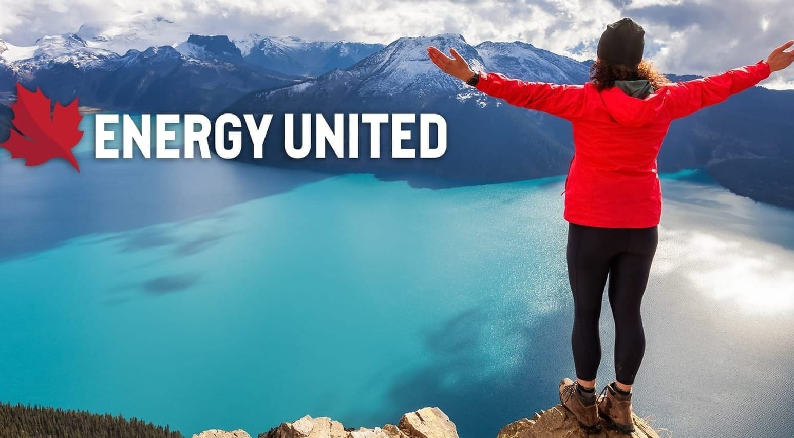 A woman in a red coat stands on a peak overlooking a lake and mountain range. White text reads ENERGY UNITED